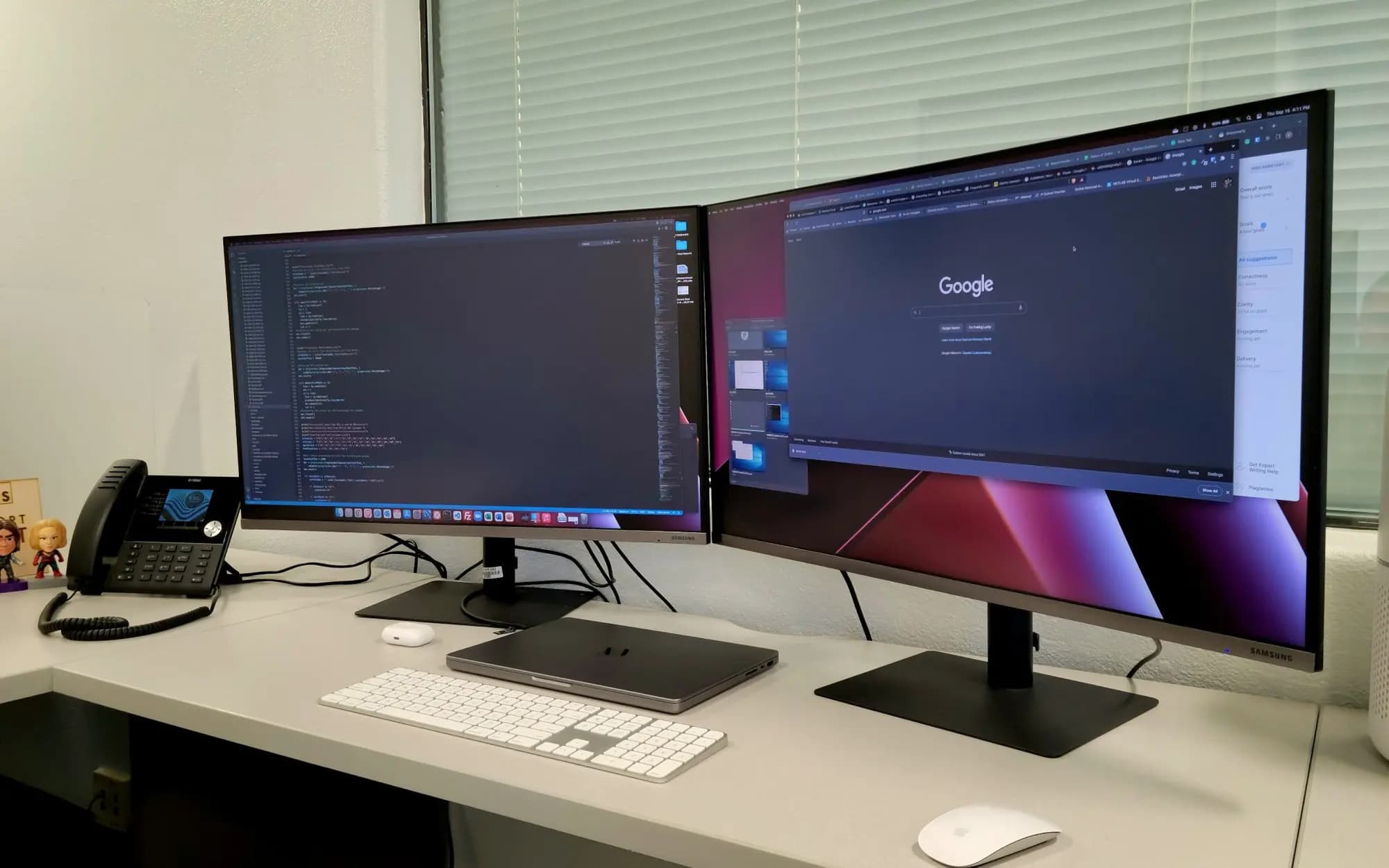 Developer desk with two monitors showing code