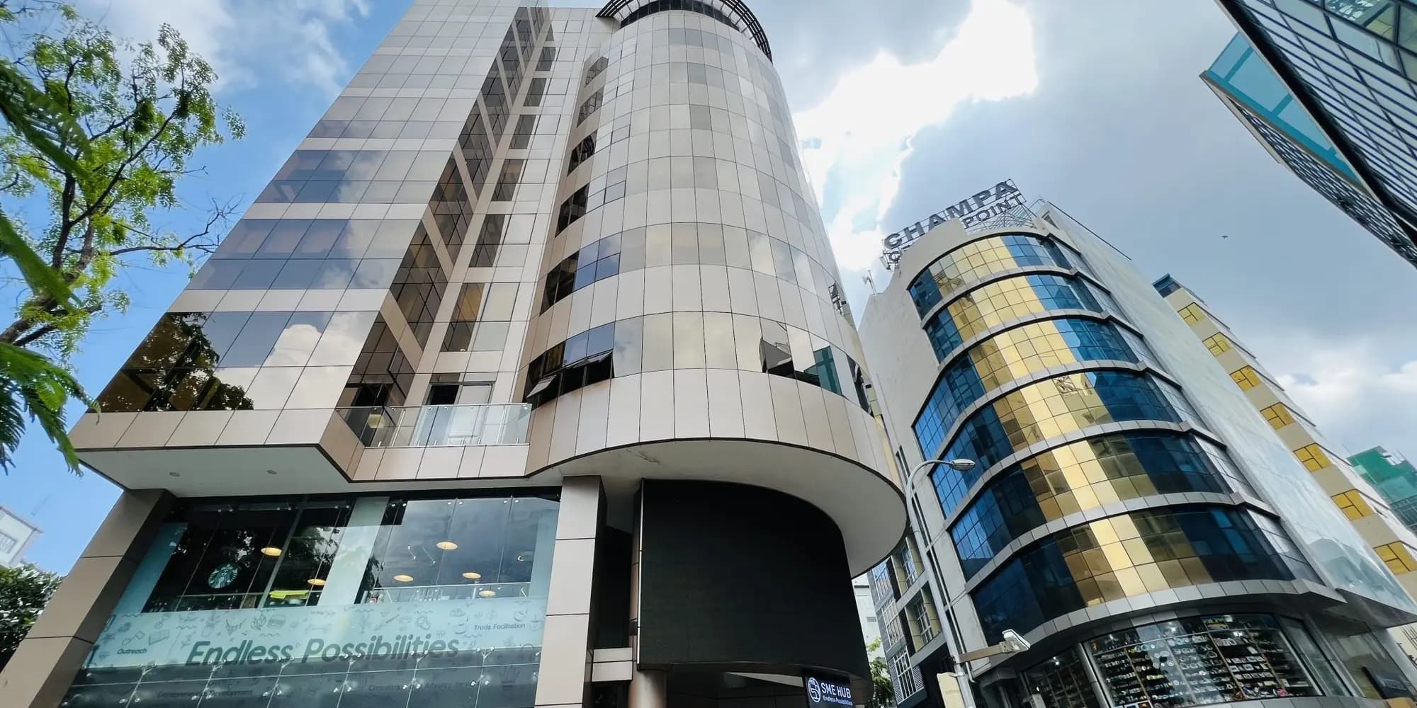 Curved glass office towers against a blue sky